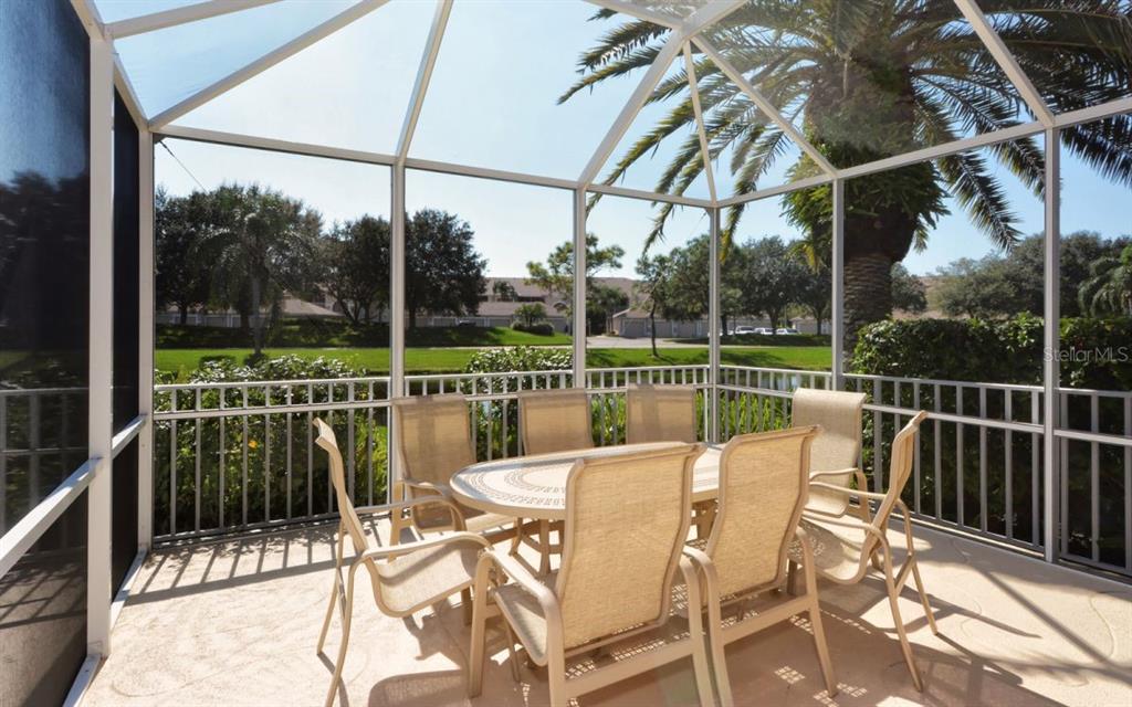 9620 Club S Circle, Unit 5105 Sarasota, FL 34238 - Photo 21 of 36 a view of a chair and tables in the balcony