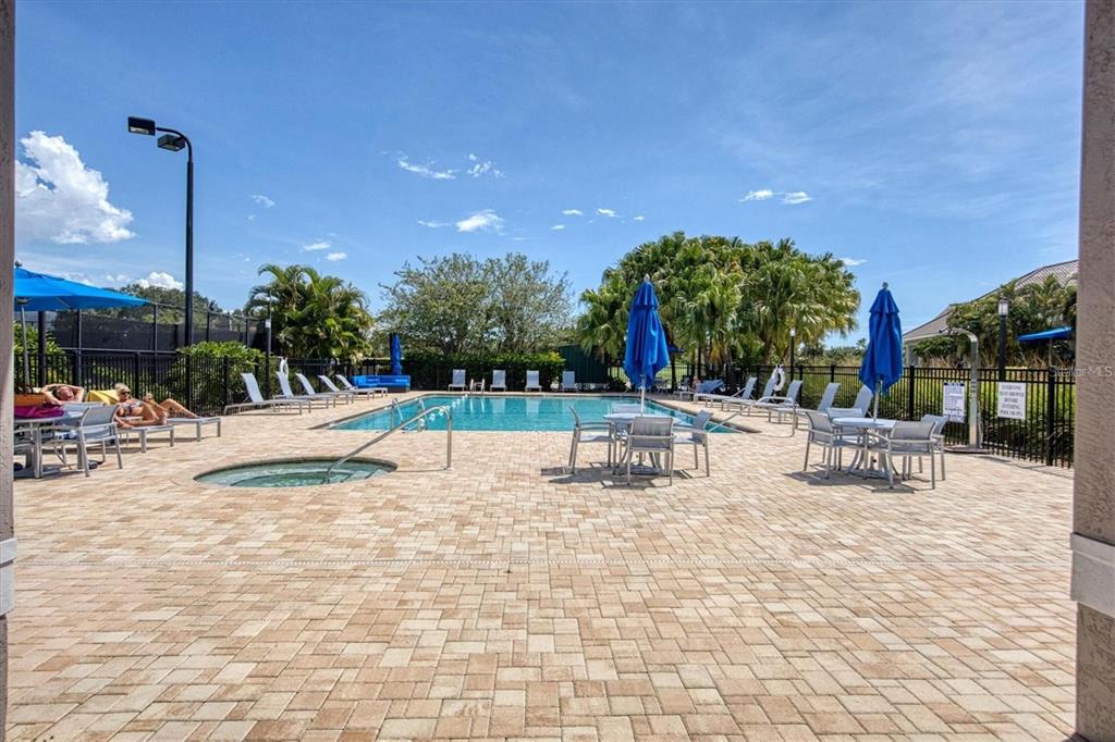 9620 Club S Circle, Unit 5105 Sarasota, FL 34238 - Photo 33 of 36 a view of a swimming pool and sitting area