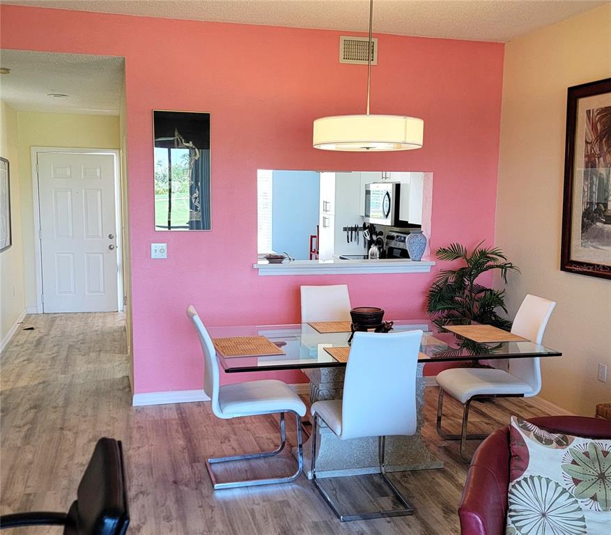 9620 Club S Circle, Unit 5105 Sarasota, FL 34238 - Photo 6 of 36 a dining room with furniture and window
