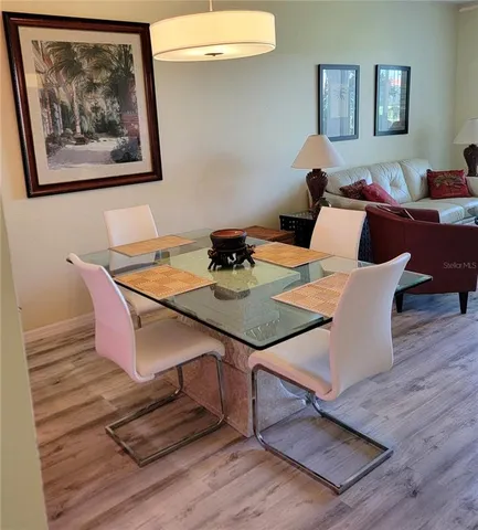 a dining room with furniture and wooden floor