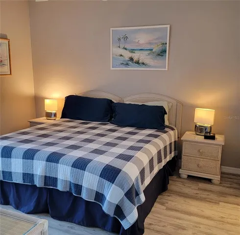 a bedroom with a bed and painting on the wall