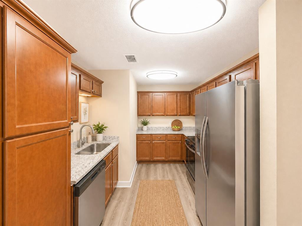 1231 Rutherford Drive Mesquite, TX 75149 - Photo 4 of 29 a kitchen with refrigerator and cabinets