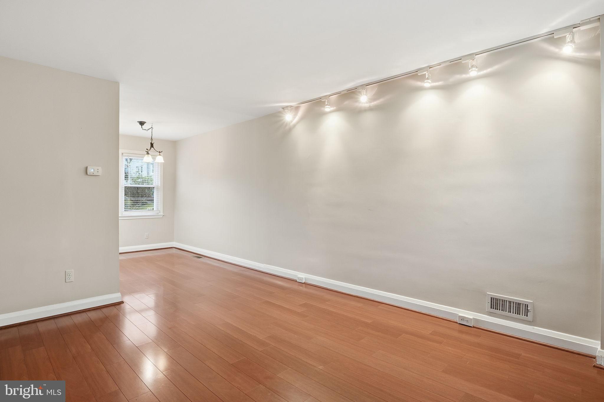 4306 Newport Avenue Baltimore, MD 21211 - Photo 15 of 44 a view of an empty room with wooden floor and a window