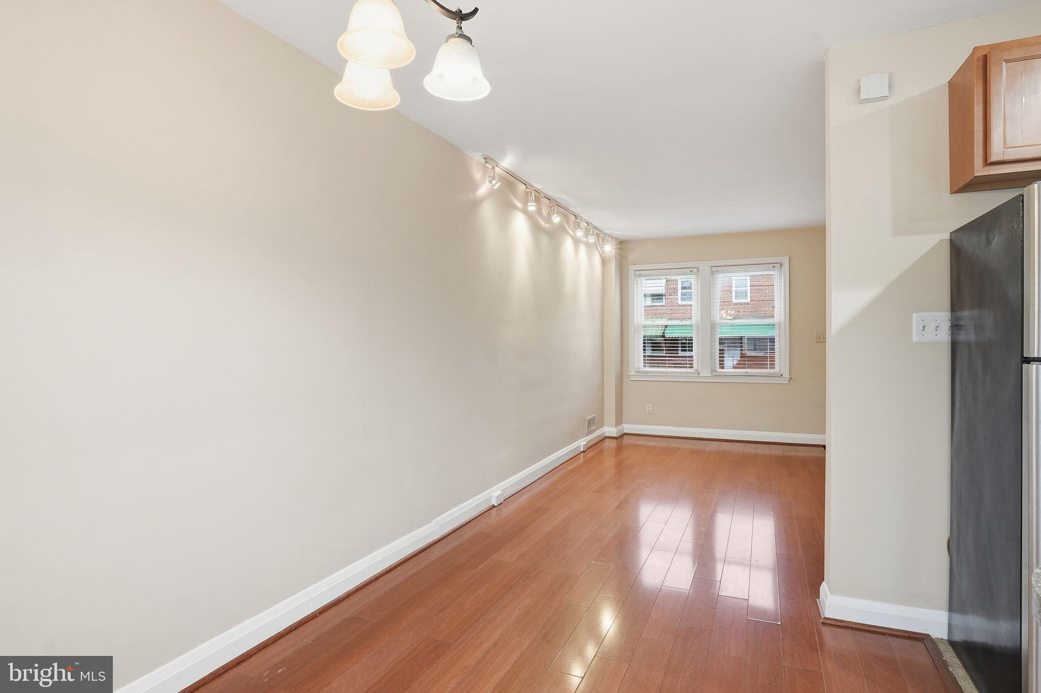 4306 Newport Avenue Baltimore, MD 21211 - Photo 16 of 44 a view of an empty room with wooden floor and a window