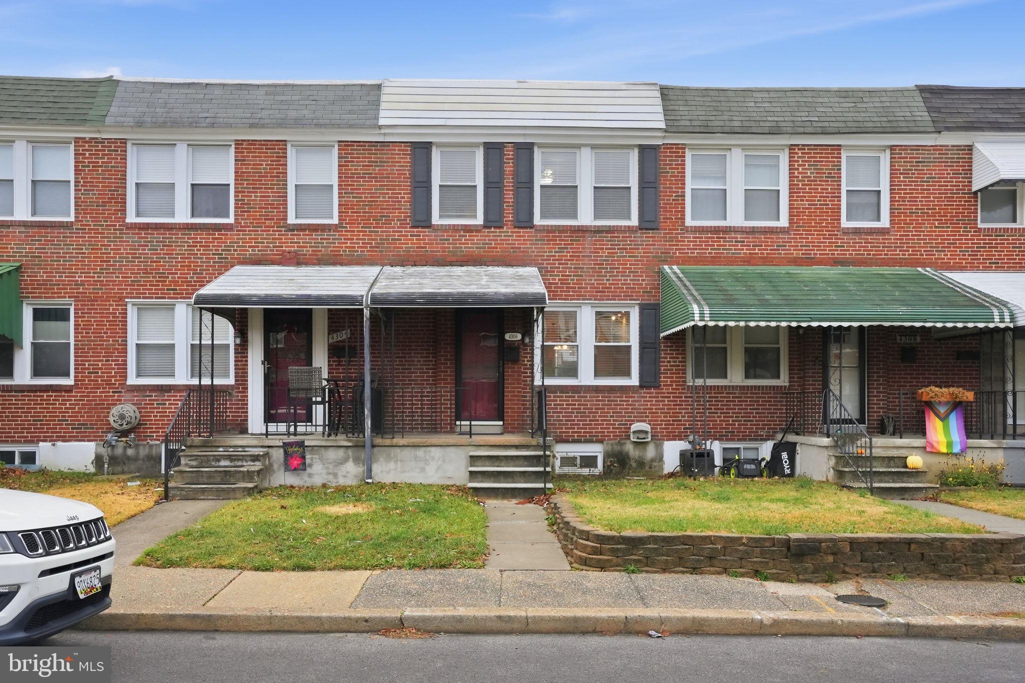 4306 Newport Avenue Baltimore, MD 21211 - Photo 2 of 44 front view of a brick house with a yard