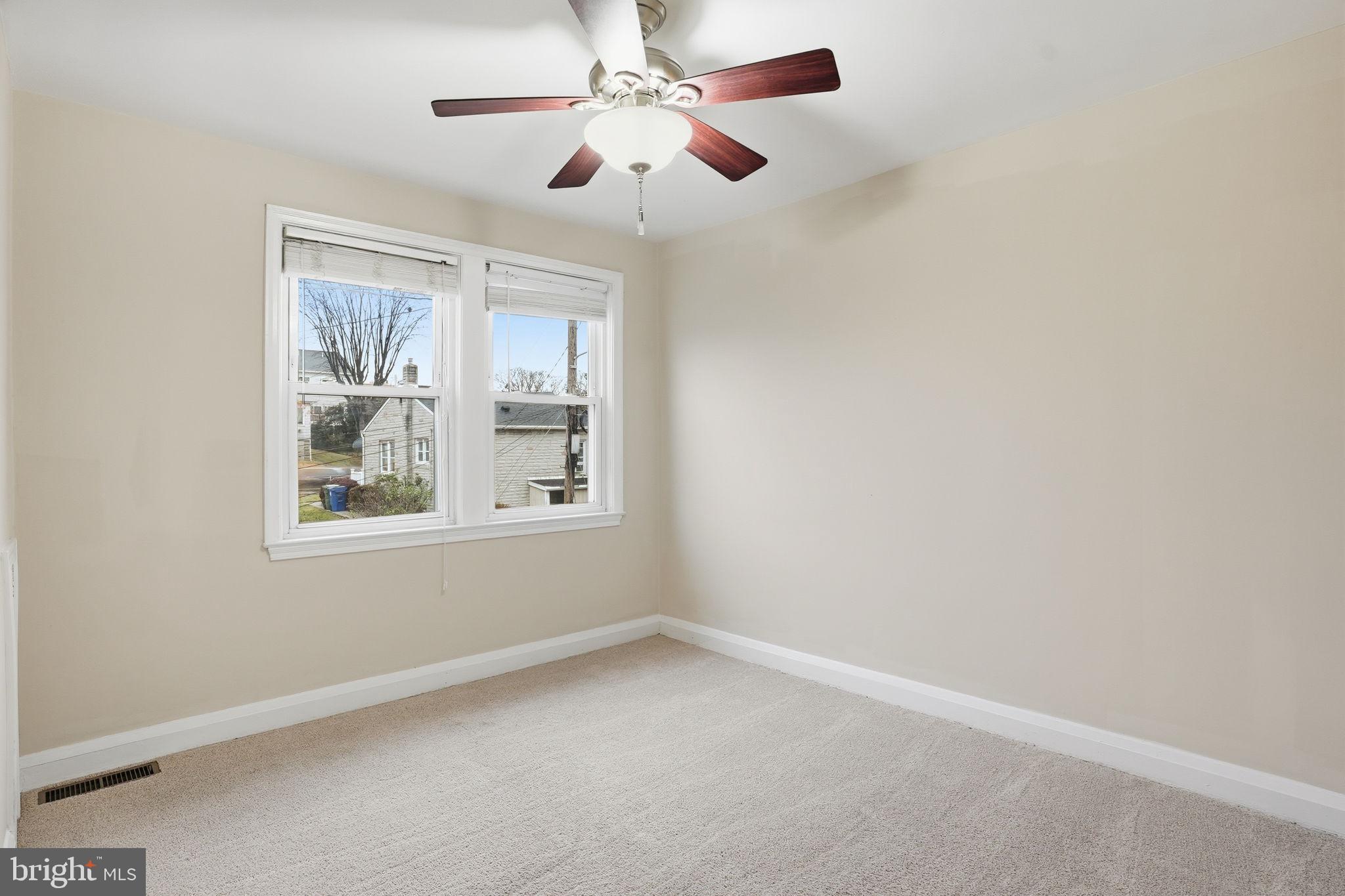 4306 Newport Avenue Baltimore, MD 21211 - Photo 23 of 44 an empty room with a window and a fan