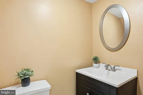 a bathroom with a toilet a sink and mirror