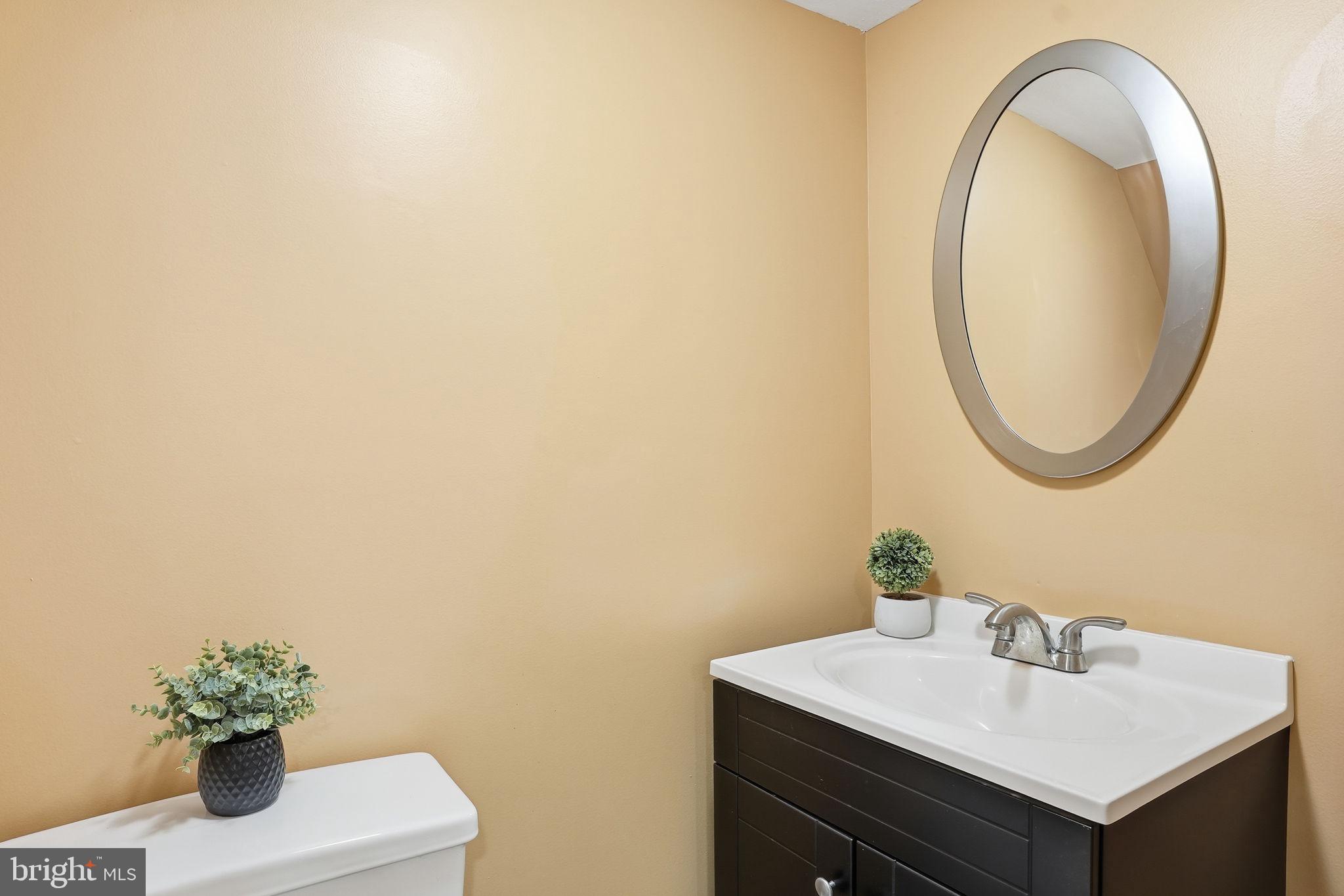 4306 Newport Avenue Baltimore, MD 21211 - Photo 31 of 44 a bathroom with a sink and a mirror