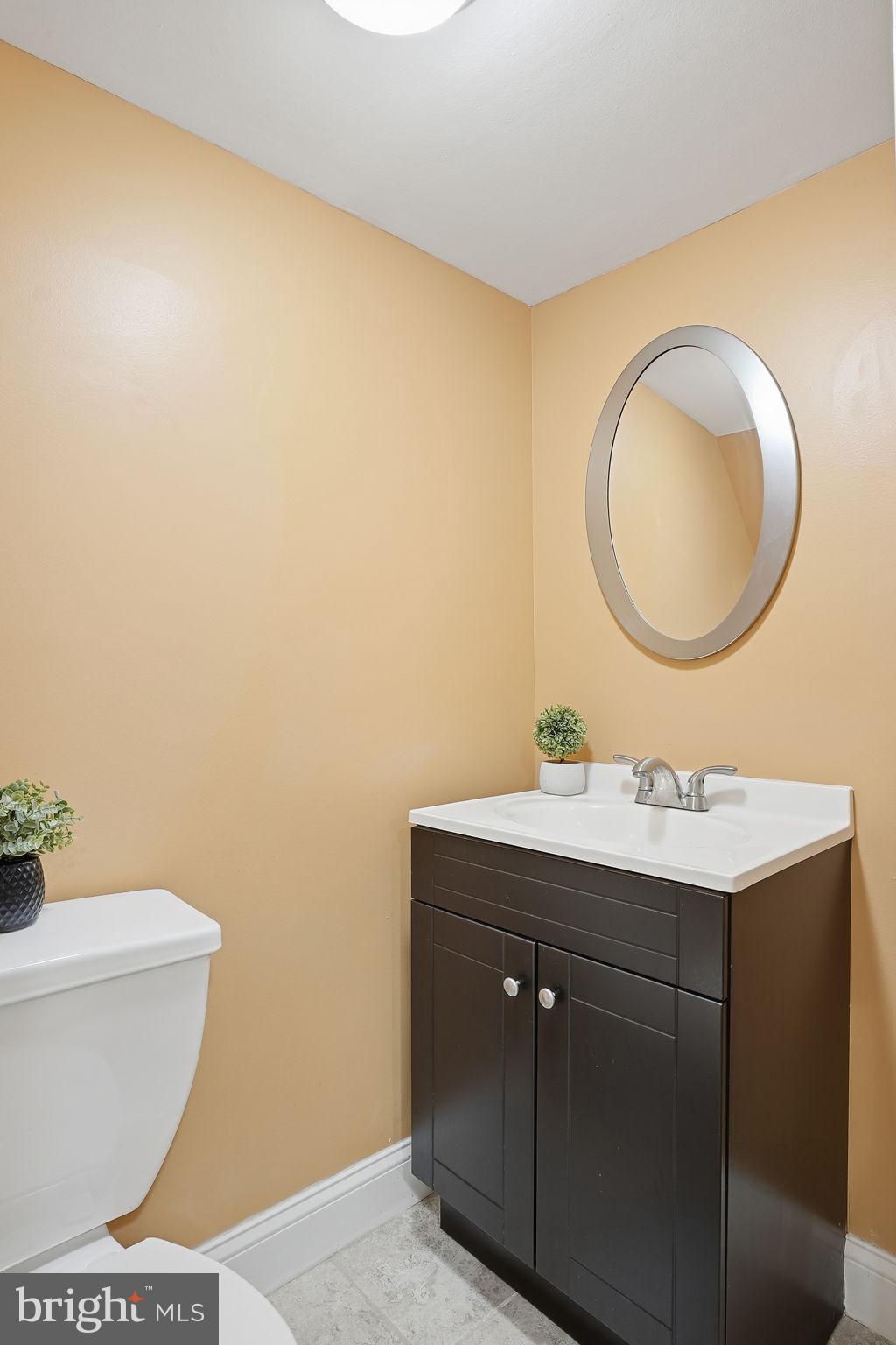 4306 Newport Avenue Baltimore, MD 21211 - Photo 32 of 44 a bathroom with a toilet a sink and mirror