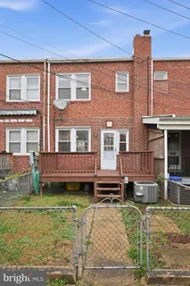 front view of a brick house with a yard