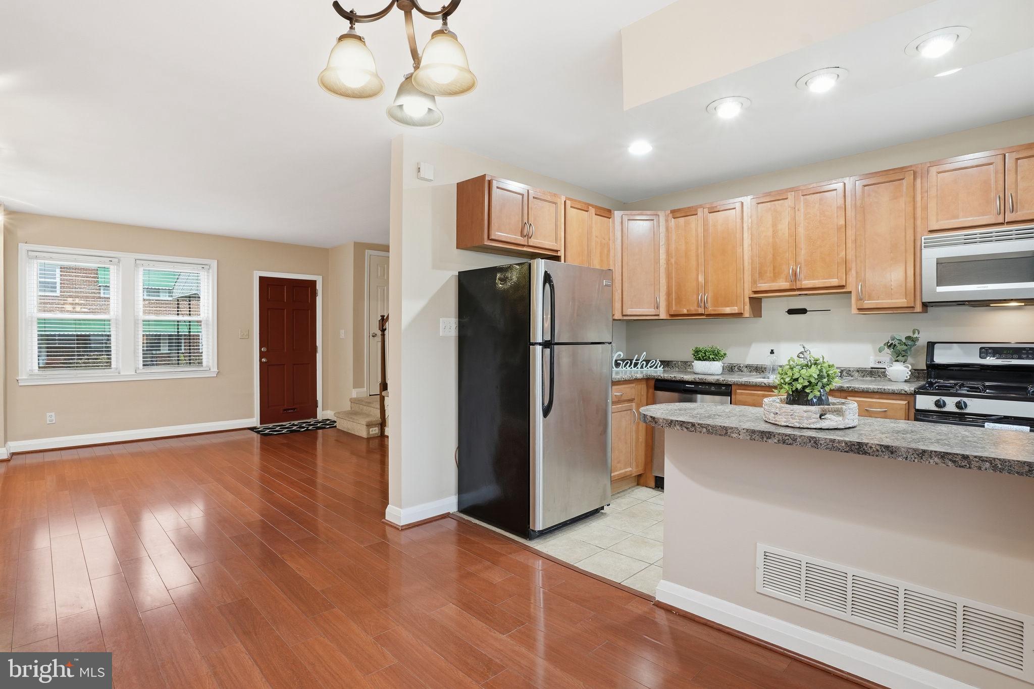 4306 Newport Avenue Baltimore, MD 21211 - Photo 5 of 44 a kitchen with stainless steel appliances granite countertop a refrigerator and a stove top oven