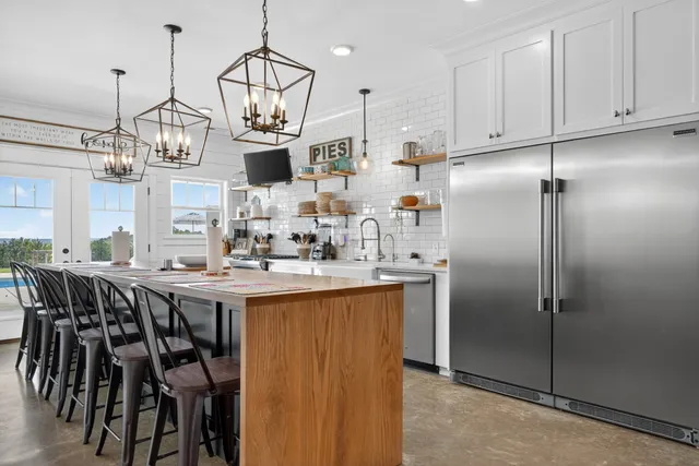 a kitchen with stainless steel appliances granite countertop a stove and white cabinets