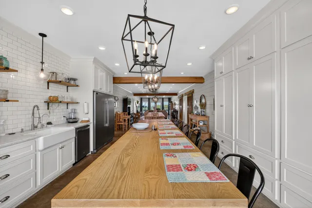 a living room with lots of furniture and a large window