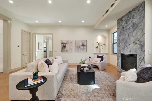 a living room with furniture and a view of kitchen
