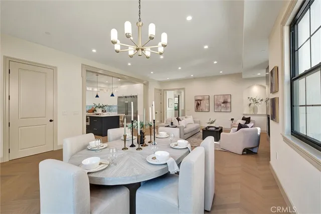 a kitchen with a table chairs sink and cabinets