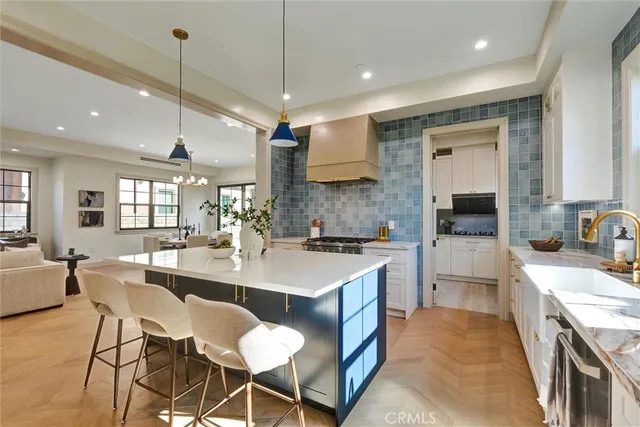 a kitchen with kitchen island a sink stove and refrigerator
