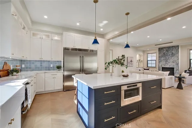 a kitchen with stainless steel appliances granite countertop a sink a stove and a refrigerator