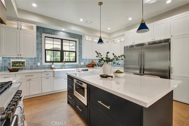 a kitchen with stainless steel appliances a sink a stove a microwave and cabinets