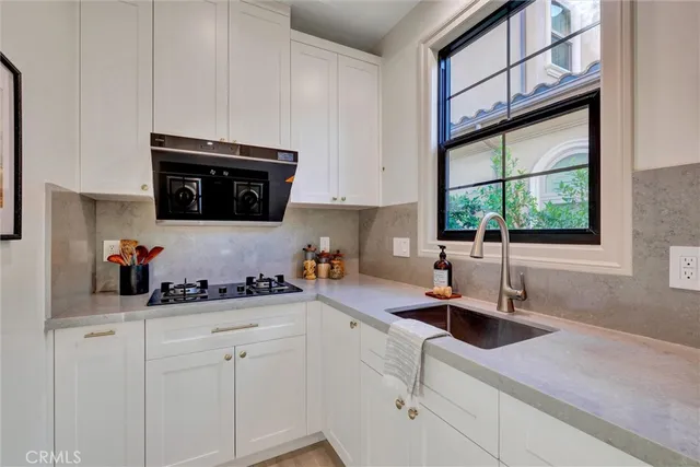 a kitchen with a sink and cabinets