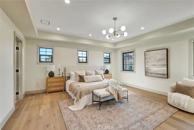 a bedroom with furniture and a wooden floor