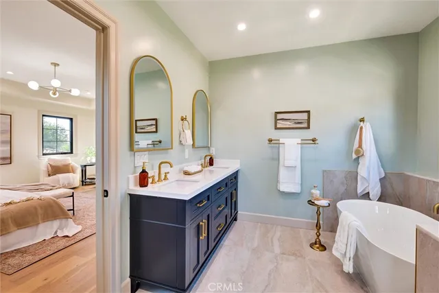 a bathroom with a tub sink and a mirror