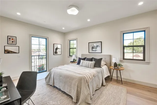 a bedroom with a bed a mirror and a window