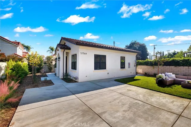 a view of a house with yard and a garden