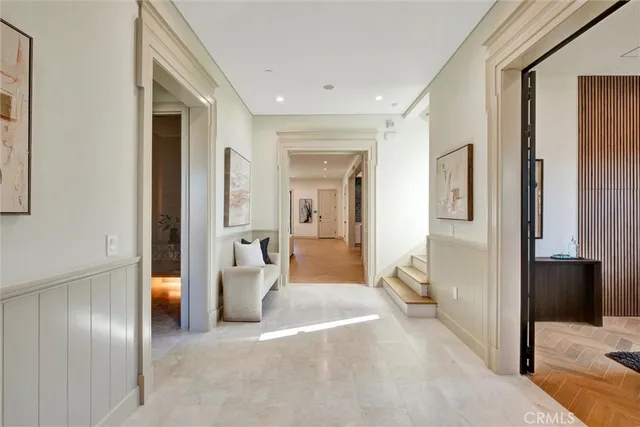 a view of a hallway with wooden shelves