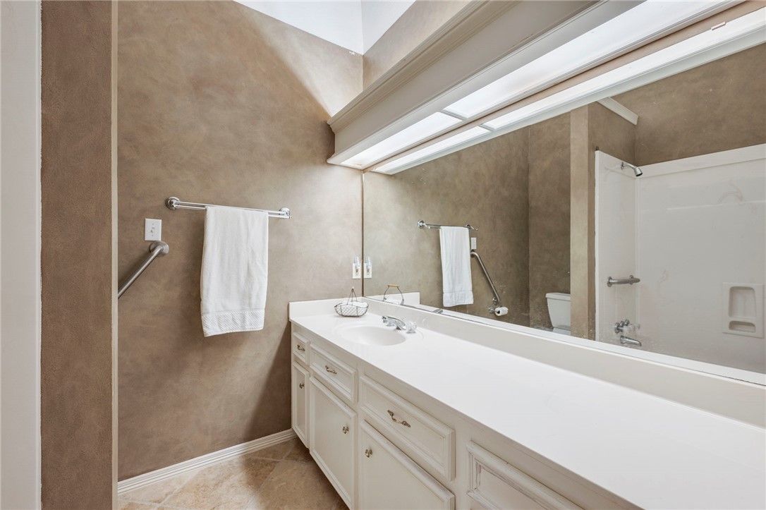 713 Willow Loop College Station, TX 77845 - Photo 24 of 39 a bathroom with a double vanity sink and mirror