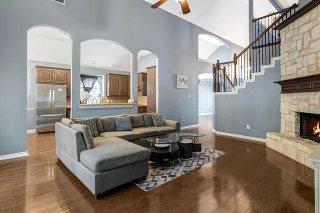 a living room with fireplace furniture and a wooden floor