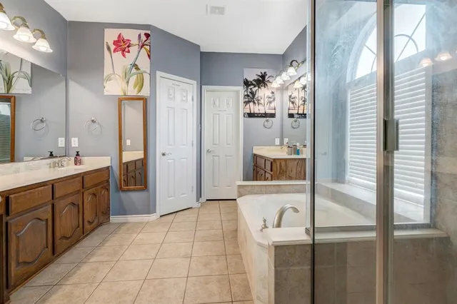 a bathroom with a bathtub sink and mirror