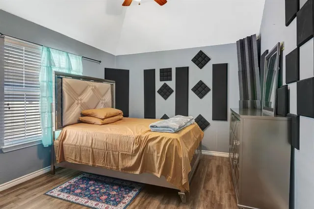 a bedroom with a bed and a painting on the wall