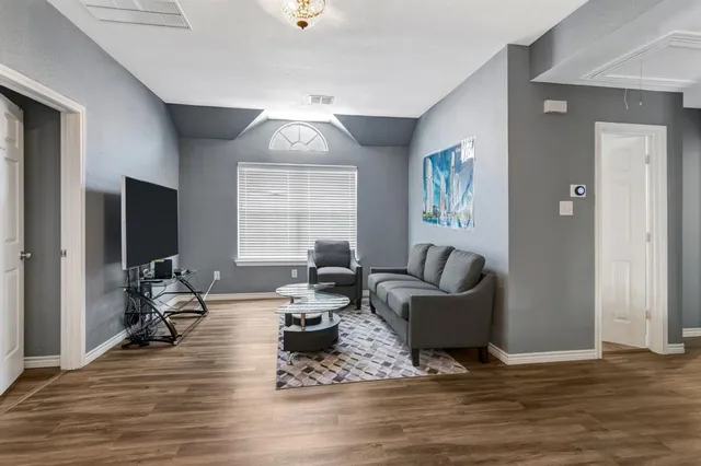 a living room with furniture window and wooden floor