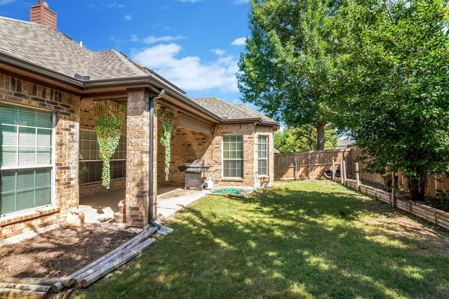 a house view with a sitting space and garden