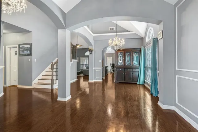 a view of a hallway view with wooden floor and staircase