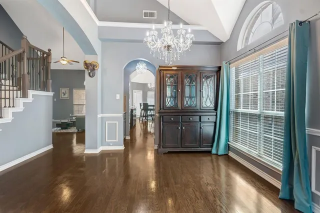 a view of a room with wooden floor and windows