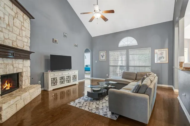 a living room with furniture a flat screen tv and a fireplace