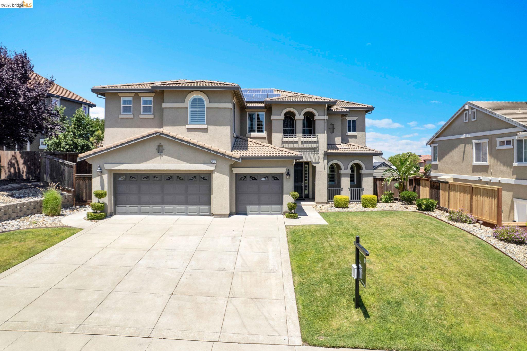 2513 Winged Foot Road Brentwood, CA 94513 - Photo 1 of 45 Stucco exterior featuring arched windows, a multi-car garage, and a concrete driveway