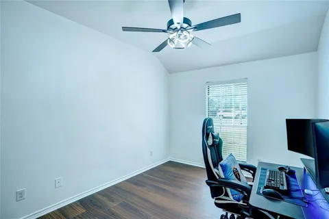 a view of a workspace with furniture and a window
