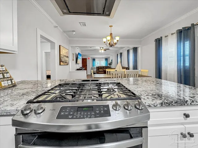 a view of a stove top oven and kitchen island