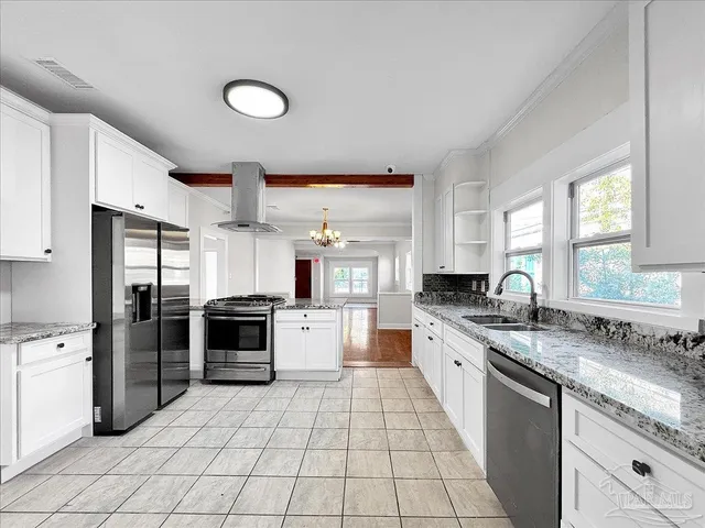 a large kitchen with a stove a sink dishwasher a refrigerator and a stove with wooden cabinets