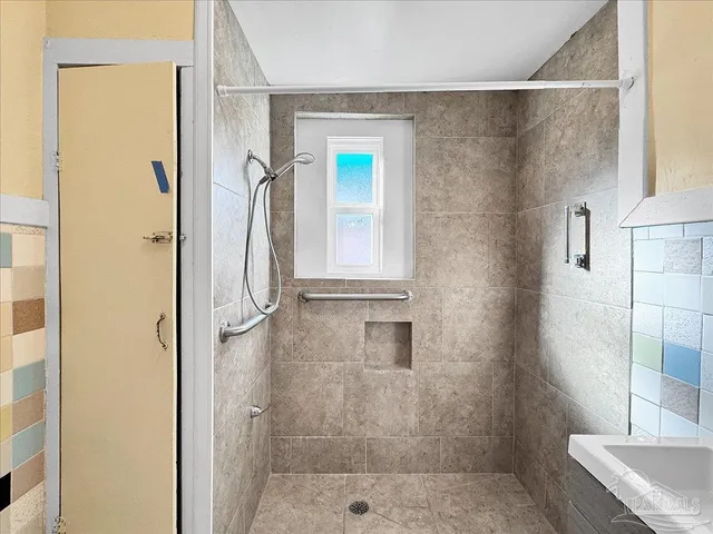 a bathroom with a granite countertop shower mirror and a sink