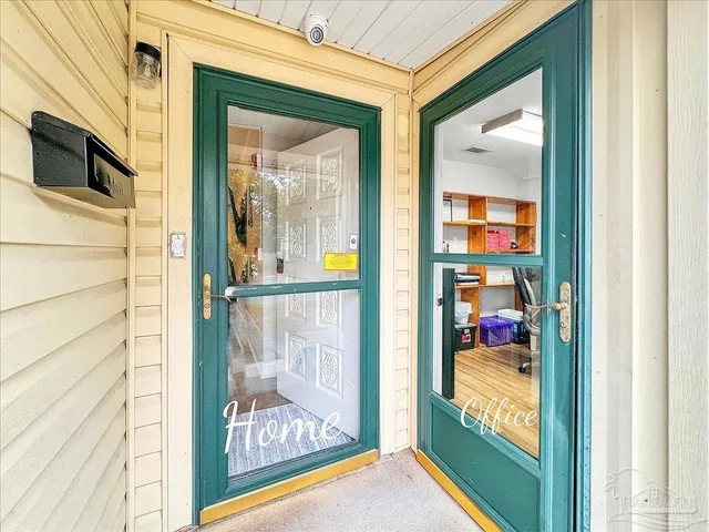 a view of a door and a living room