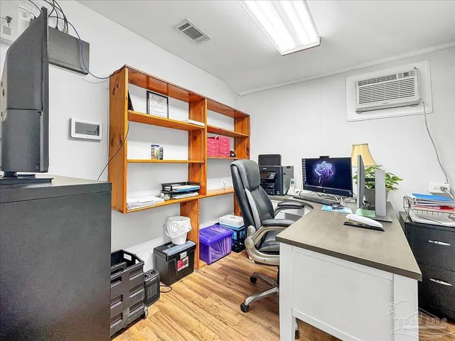 a view of a workspace with furniture and a window