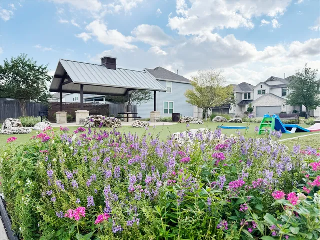 a small garden covered with lots of flower and trees