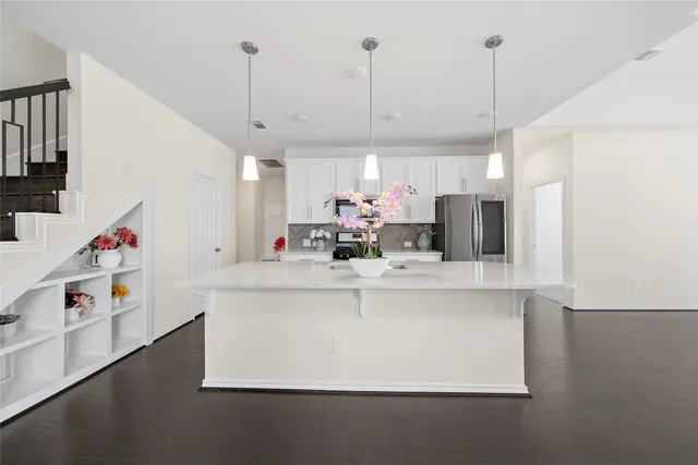 a kitchen with kitchen island a white counter top space a sink and appliances