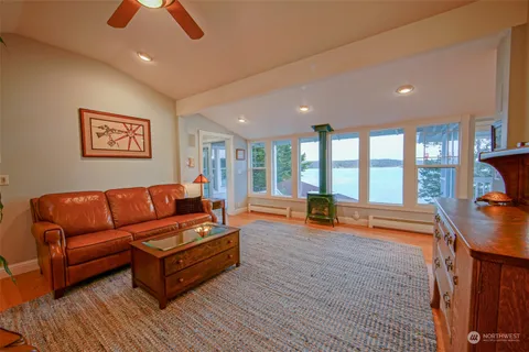 a kitchen that has a sink and chairs in it