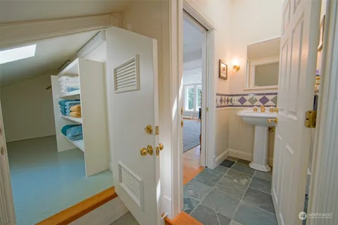 a balcony with wooden floor and potted plants