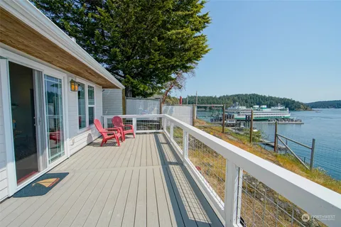 a dining room with wooden floor a chandelier a glass table and chairs