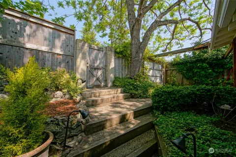 a living room with furniture a ceiling fan and a flat screen tv